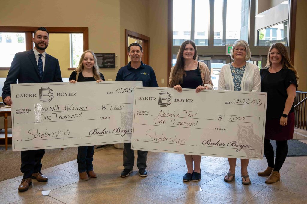 Baker Boyer presenting scholarships to students