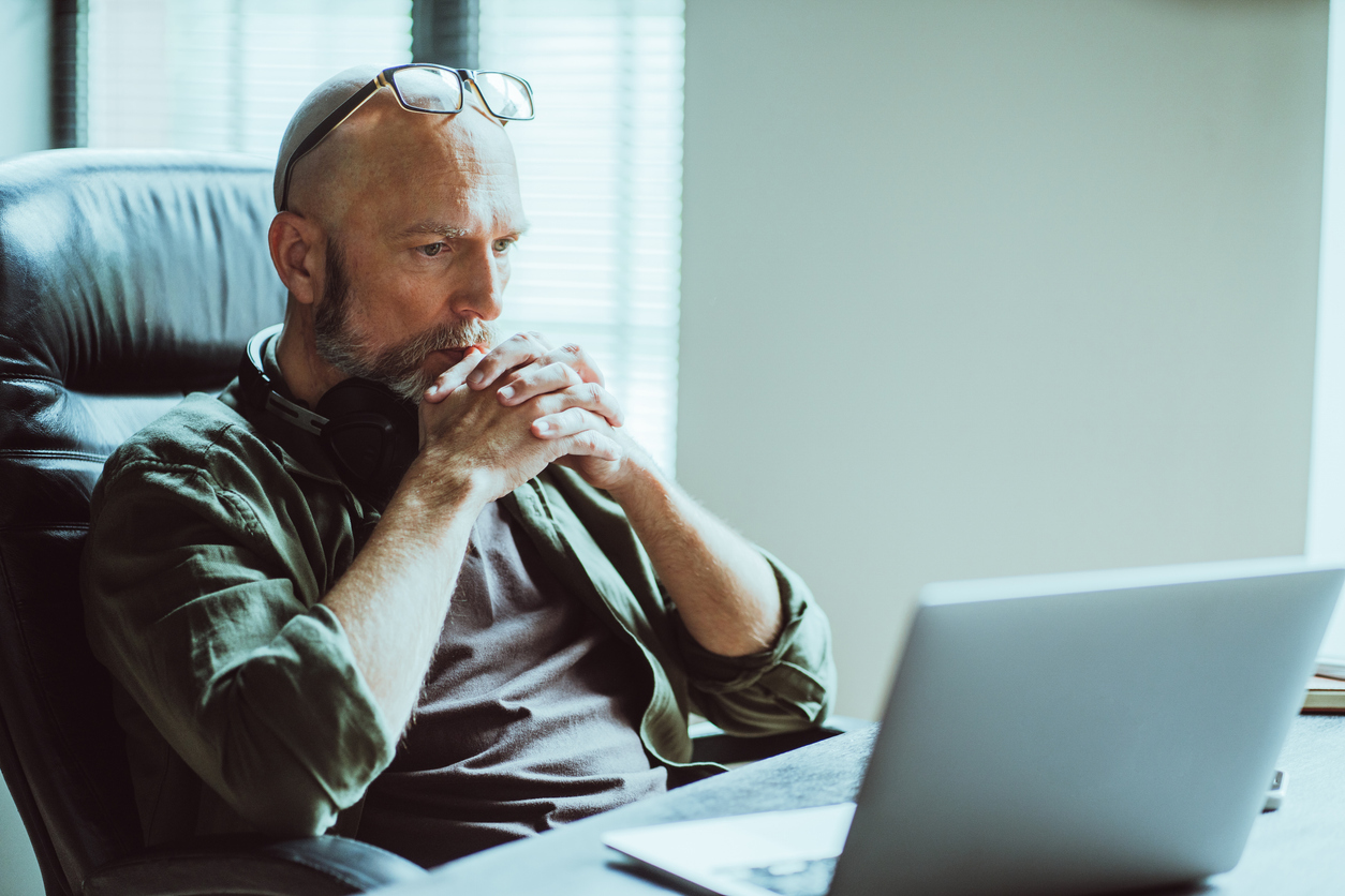 Man sitting at a desk contemplating life