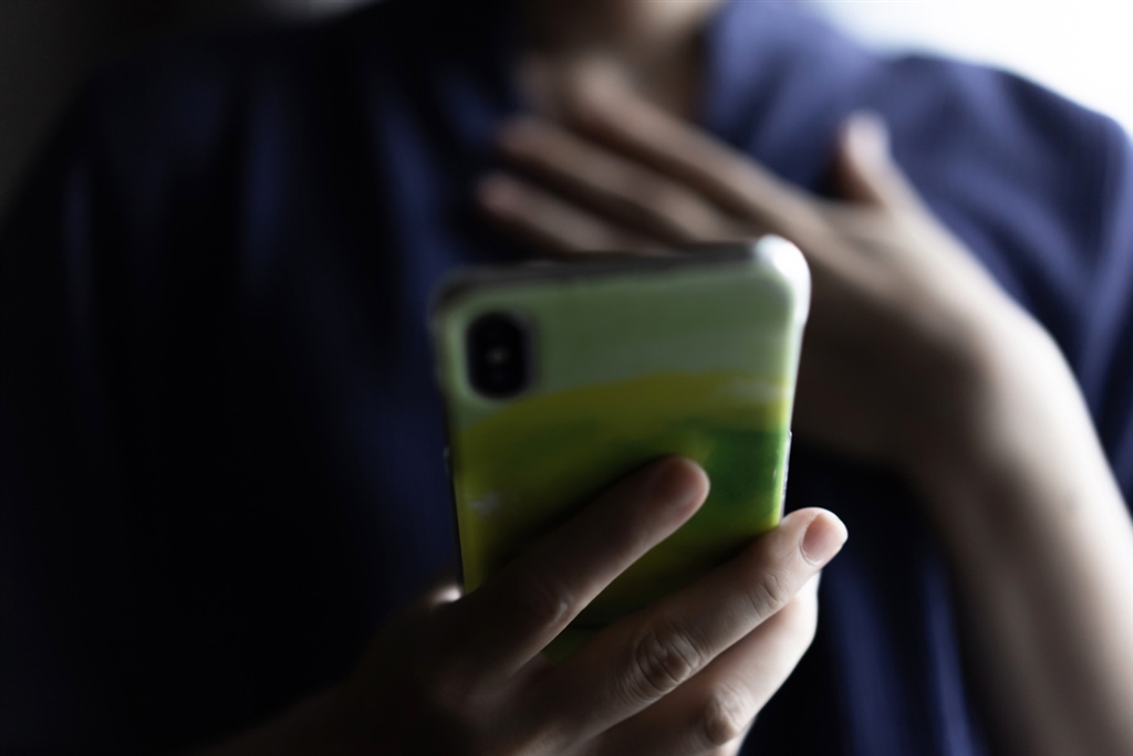 Person holding their phone