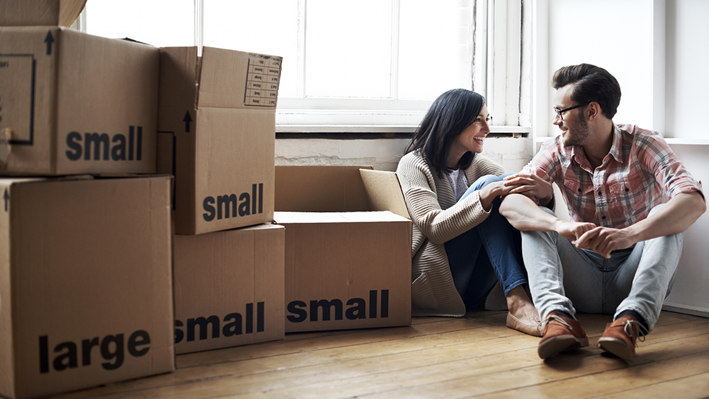 Young couple unpacking boxes