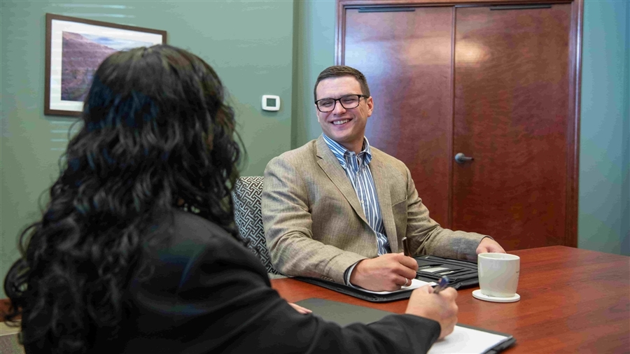 Stuart GIllin meeting with individual talking about endowements