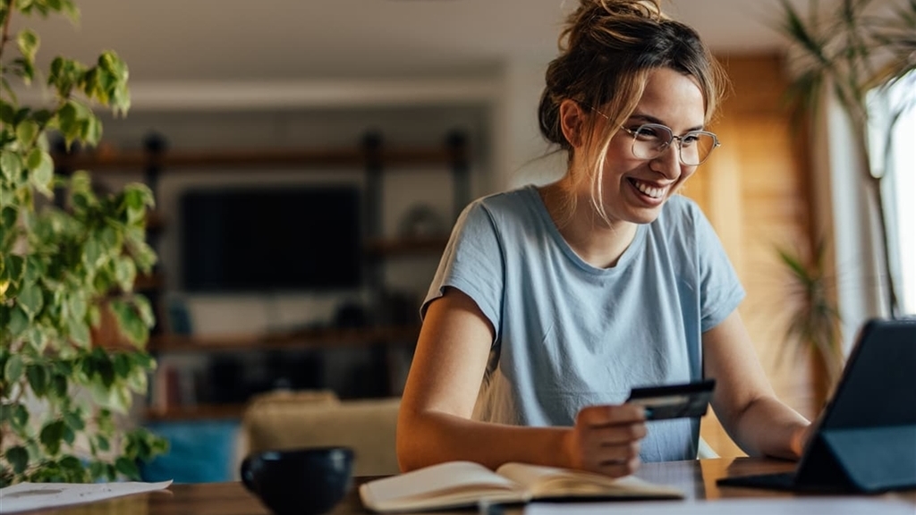 Woman on laptop with credit card securing accounts