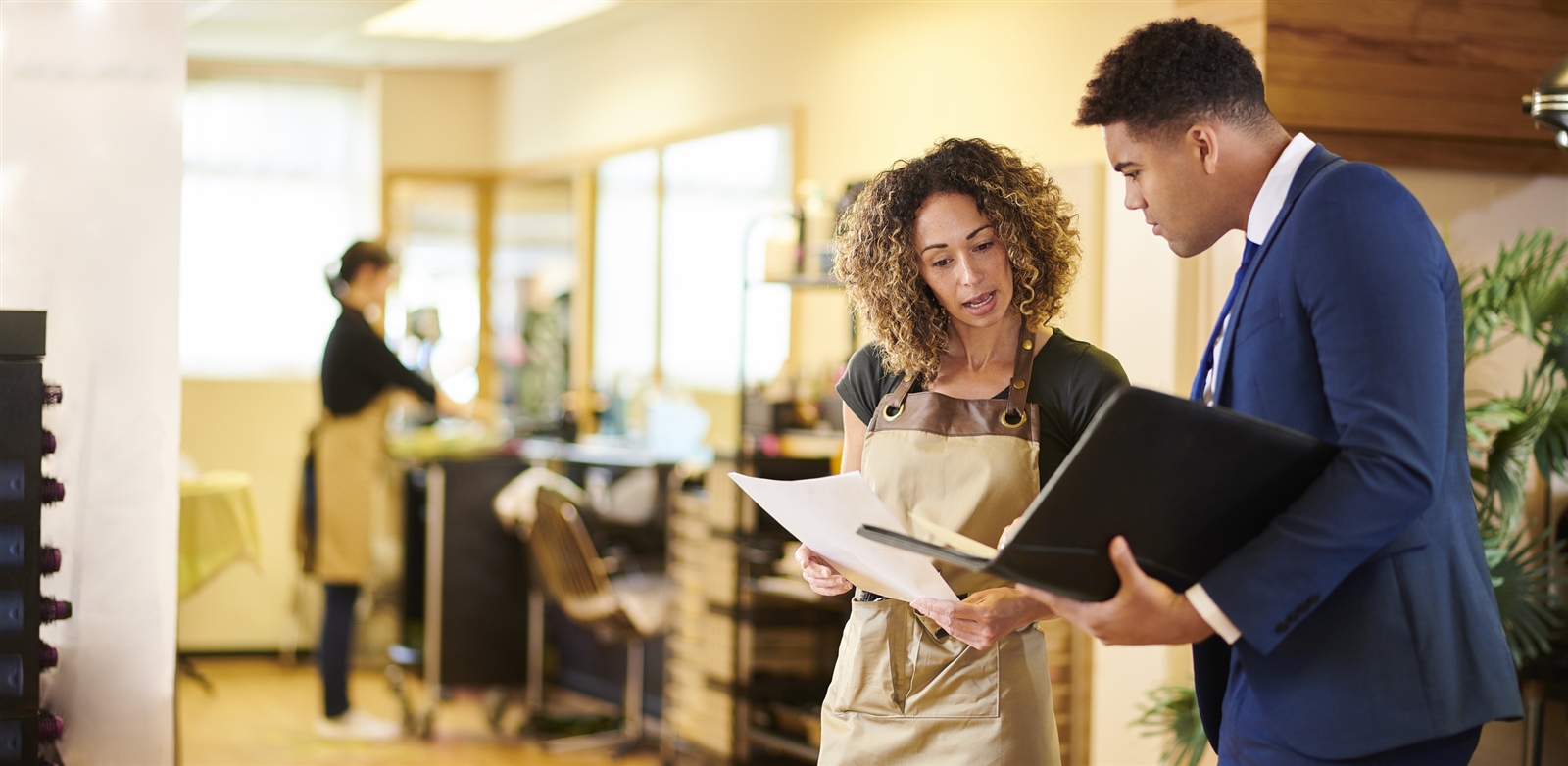 bi-racial business owner talking to banker about cash management services