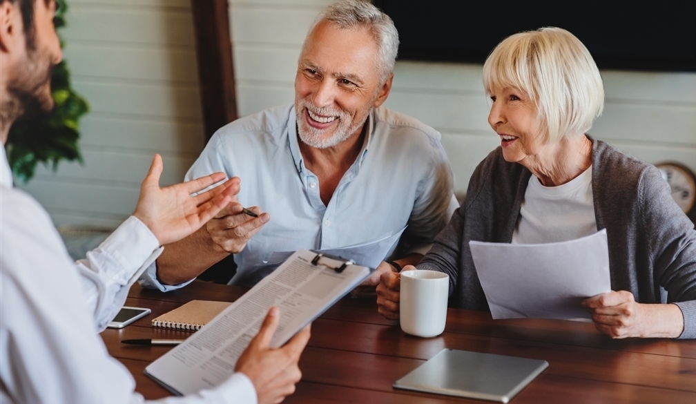 Older couple talking with financial advisor