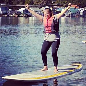 Jessica standing on a paddle board