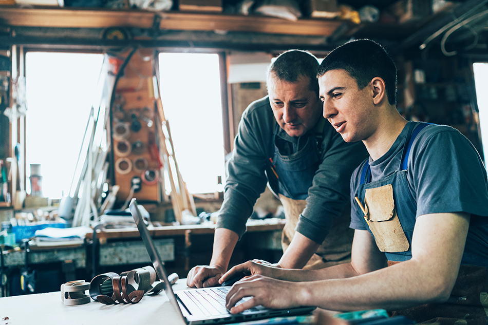 Father and son working together on business plan