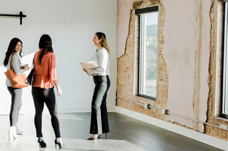 Real estate agent meeting with prospective clients in empty business space