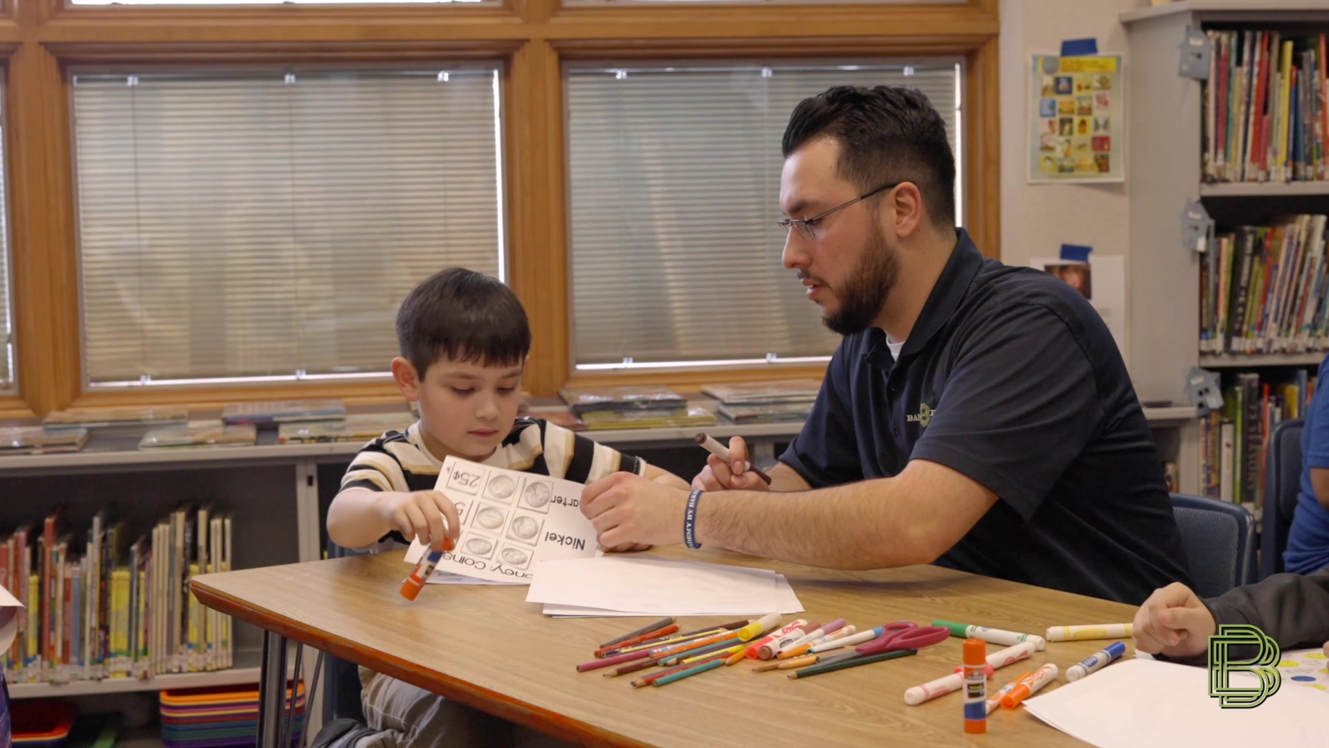 Baker Boyer employee in the classroom teaching child by our Finance Academy program