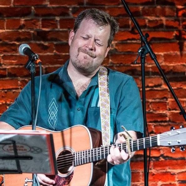 Adam Kirtley playing guitar