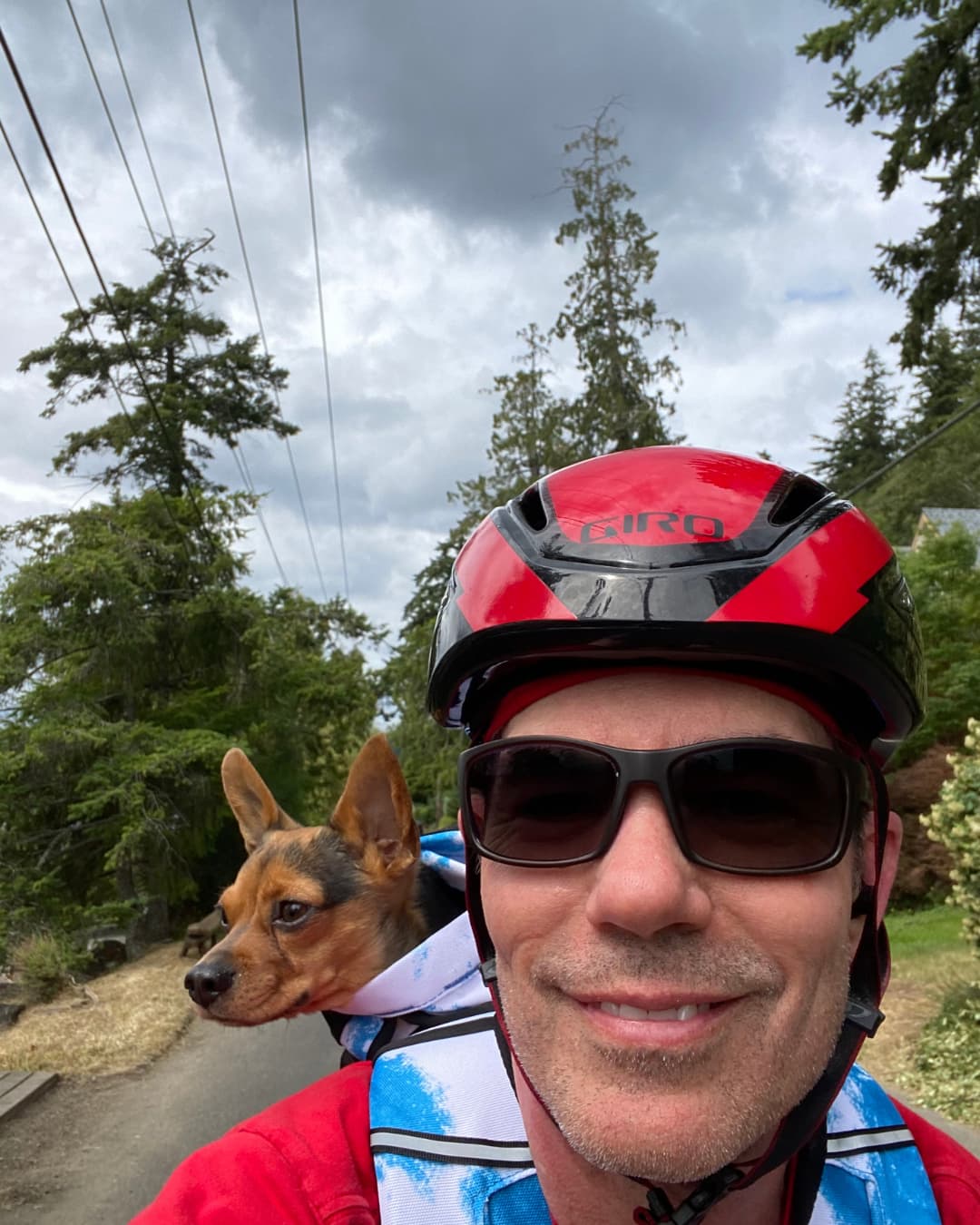 Alan Crain riding a bike with his dog