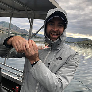 Brian on a boat with a fish