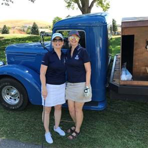 Jan with coworker at golf event
