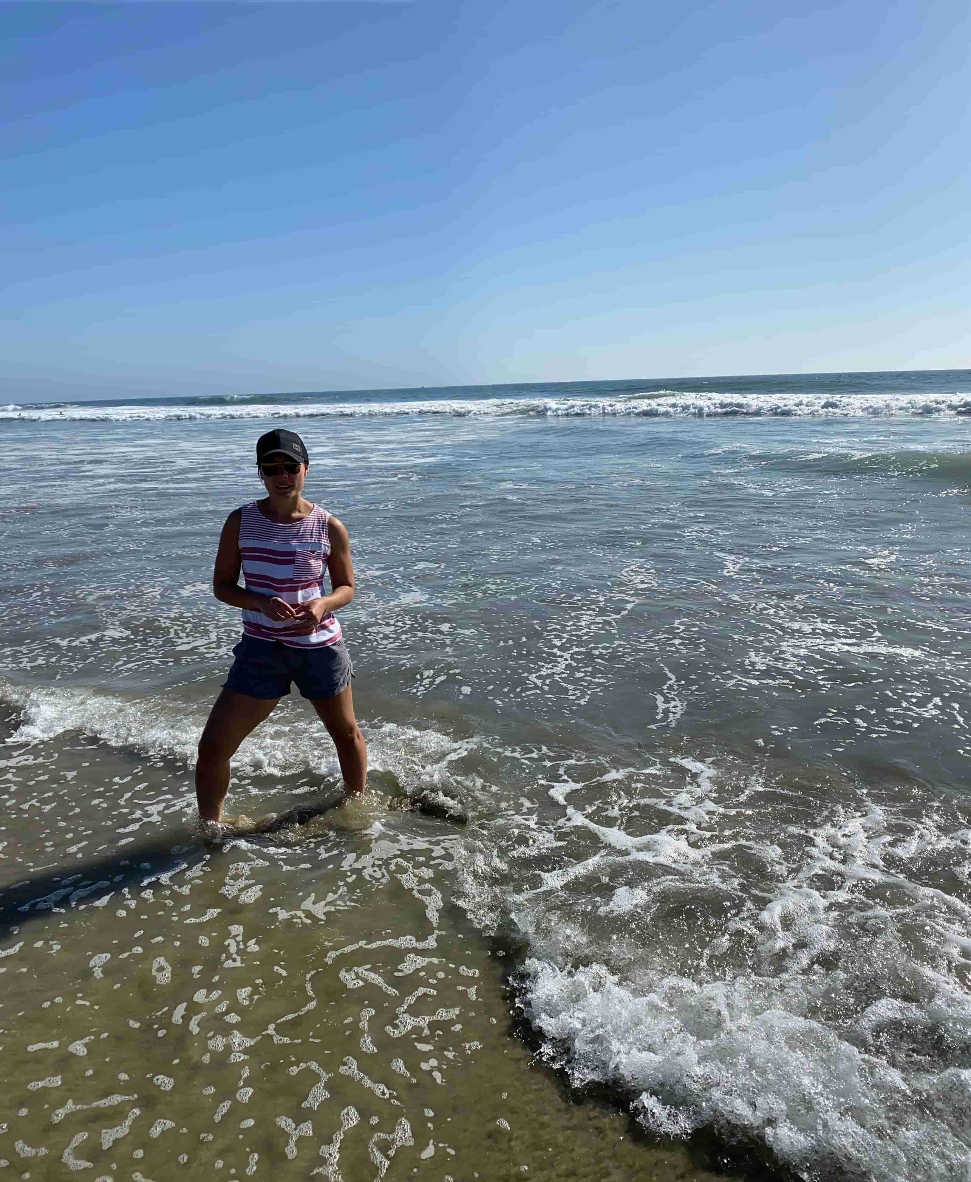 Jessie standing on a beach