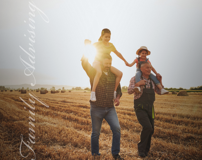 Multi generational business owner farmers with grandchildren walking a field