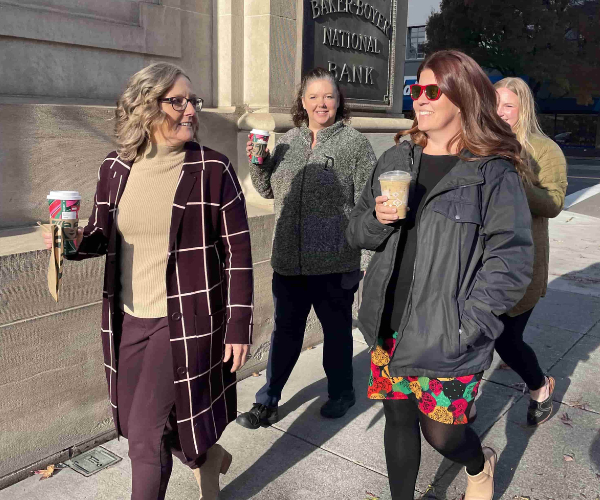 group of employees walking outside of Main Office on a Starbucks run