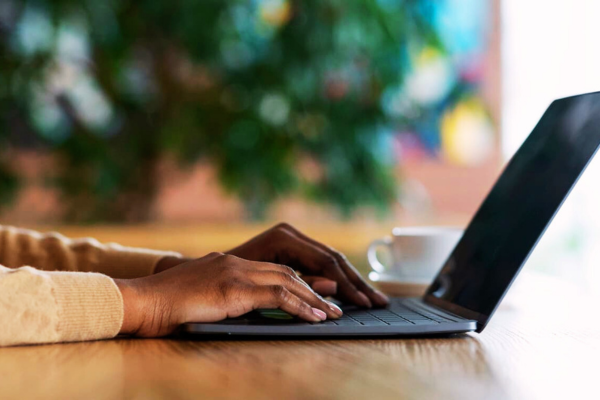 close up of hands on laptop