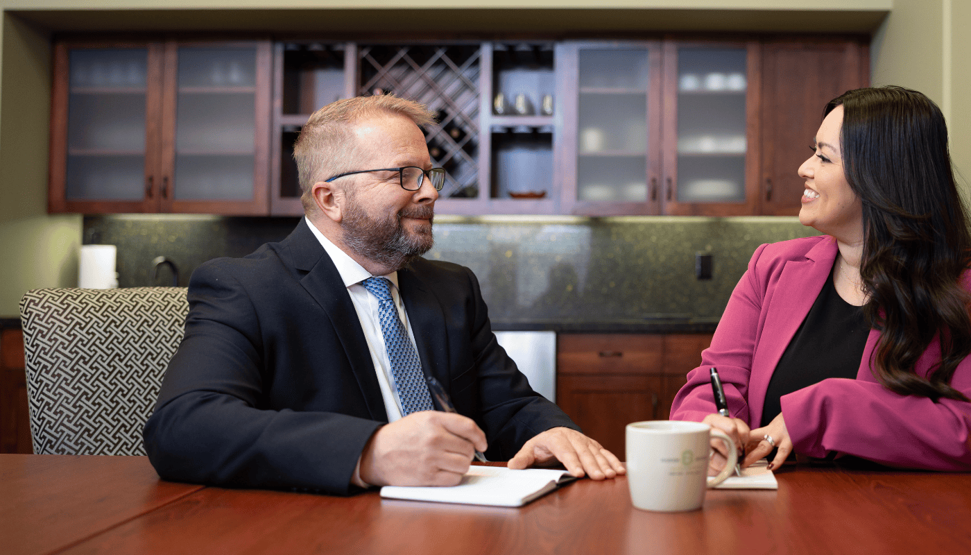 Gary and Marisol Business Advisors and Lenders talking in a meeting room at the Tri-Cities Branch