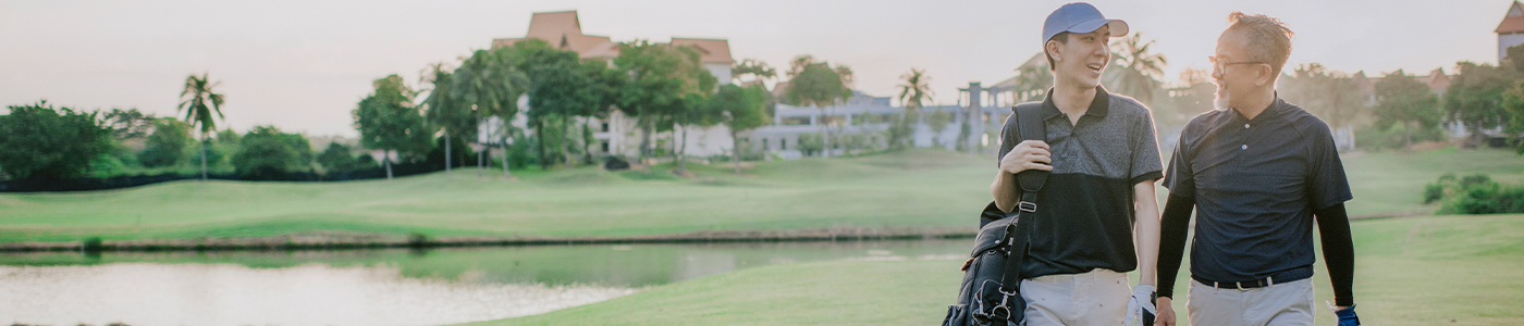 father on golf course with son talking about how to transition business