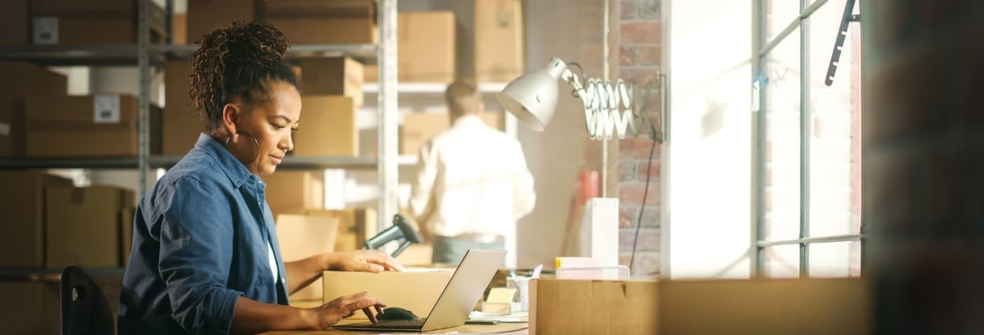 Small business owner operating business on laptop